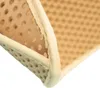 A close-up view of the corner of a beige cat litter mat with a honeycomb pattern and a fabric border. Produktbild-Vorschau