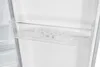 An internal view of a refrigerator compartment, focusing on a transparent shelf. Podgląd zdjęcia produktu