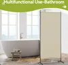 A bathroom with a freestanding bathtub and a room divider. Voir les images du produit