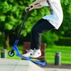 A person is riding a blue trick scooter in a skate park. Náhľad obrázku produktu