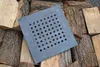 A square cast iron grate with many small holes is placed on a pile of chopped firewood. Anteprima dell’immagine prodotto