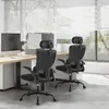 Two black office chairs are shown in an office setting with blinds and a window in the background. Produktbild-Vorschau