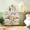 A bookshelf filled with books and decorative items next to a bed and a floor lamp. Podgląd zdjęcia produktu