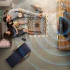 A family is relaxing on the floor watching TV, with a cat nearby. The scene depicts a cozy home environment. Voir les images du produit
