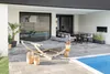 An outdoor patio area with a hammock, dining set, and pool. Produktbild-Vorschau