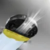 A robot vacuum cleaner is shown from a low angle, cleaning a surface with a yellow mop pad. White lines indicate airflow or suction. Produktbild-Vorschau