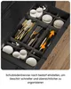 A close-up view of an open drawer containing a cutlery organizer filled with various utensils and some small white containers. Voir les images du produit