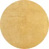 A circular rug with a textured, golden-brown surface.