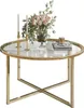 A round glass-top coffee table with a gold metal frame, decorated with a vase of pink roses and two white candles. Náhľad obrázku produktu