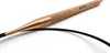 A close-up shot of a circular knitting needle with a wooden handle and a copper tip. Produktbild-Vorschau