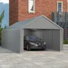 A car is parked inside a gray tent garage in front of a brick building. Produktbild-Vorschau