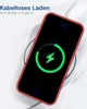 A smartphone with a red case is placed on a wireless charger, showing a charging animation on its screen. Produktbild-Vorschau