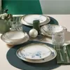 A table setting with dinnerware, glasses, and candles. Produktbild-Vorschau