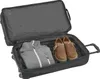 An open suitcase with clothing and shoes inside. Produktbild-Vorschau
