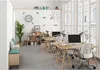 A modern office space with multiple desks and chairs, decorated with wall decals of paper airplanes and a lightbulb. Produktbild-Vorschau