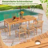 A wooden dining table and chairs set up on a patio next to a swimming pool, with an umbrella providing shade. Anteprima dell’immagine prodotto