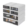 A stack of white storage boxes with transparent drawers, filled with cosmetics and toiletries. Podgląd zdjęcia produktu