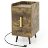 A product shot of a nightstand with a wood-grain finish and black legs, placed on a white background. Podgląd zdjęcia produktu