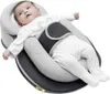 A baby lying in a specialized sleeping aid. Produktbild-Vorschau