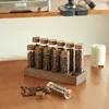 Coffee beans stored in individual glass vials on a wooden stand. Produktbild-Vorschau