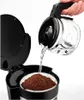 A hand is pouring water from a coffee pot into a coffee maker with coffee grounds in a filter. Náhľad obrázku produktu