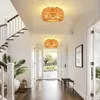 A hallway with two rattan ceiling lamps, a staircase, and an open door leading outside. Anteprima dell’immagine prodotto