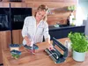 A woman is using a vacuum sealer machine in a kitchen environment. Náhľad obrázku produktu