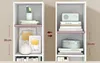 Two identical white bookshelves side-by-side, each with different items on their shelves, with measurement indicators between them. Produktbild-Vorschau