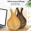 Two aroma diffusers on a wooden desk next to a laptop. Produktbild-Vorschau