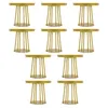 Ten identical gold-colored round tables with decorative legs are arranged in rows against a white background. Podgląd zdjęcia produktu