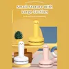 Three cartoon-styled mini vacuum cleaners in yellow, white, and pink are displayed on a yellow and blue background with decorative elements. Produktbild-Vorschau