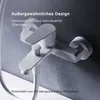A close-up studio shot of a white bathtub faucet against a textured gray background. Produktbild-Vorschau