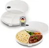 Two white divided microwave-safe plates with lids. One plate is empty and shown open, with the lid partially covering it. The second plate is filled with spaghetti, vegetables, and stew, and is also shown open with the lid partially covering it. A small si Produktbild-Vorschau