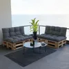 A balcony with a view of the ocean, furnished with pallet furniture and cushions. Voir les images du produit