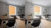 A living room with a dining table and chairs in the foreground and a sofa and wall art in the background. Produktbild-Vorschau