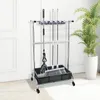 A cleaning tool organizer stand with mops and a broom on a carpeted floor in front of a white door and a potted plant. Podgląd zdjęcia produktu