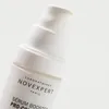 A close-up shot of a white serum bottle with a pump dispenser. Produktbild-Vorschau