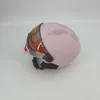 A pink helmet with a brown visor is shown against a white background. Anteprima dell’immagine prodotto