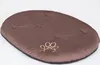 A brown oval pet bed with a paw print logo on a white background. Produktbild-Vorschau