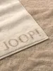 A close-up of a JOOP! towel with the brand name embossed on it, placed on a textured surface. Anteprima dell’immagine prodotto