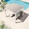 A white aluminum pergola with a slatted roof is set up next to a swimming pool, with two lounge chairs underneath. Náhled obrázku produktu
