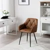 A brown armchair with black legs is placed on a rug in a room with a desk and a cabinet. Produktbild-Vorschau