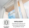 Close-up of a white window handle and frame, with a blue sky and tan building visible through the open window. Text and an icon describing 'Open Window Detection' are in the lower section. Produktbild-Vorschau