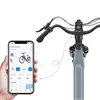 A smartphone displaying an e-bike app is held in front of the handlebars and front fork of an e-bike. Produktbild-Vorschau