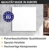 A white infrared heater is mounted on a gray wall, with a "Made in EU" logo and marketing text below. A chair and brick wall are visible in the background. Produktbild-Vorschau