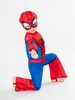 A child wearing a Spiderman costume on a white background. Produktbild-Vorschau