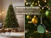 A split image showing a decorated Christmas tree in a living room on the left, and a close-up of Christmas tree ornaments and a small green decorative item on the right. Voir les images du produit