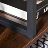 A close-up shot of a table's corner, showing the metal frame and wooden shelf. Voir les images du produit
