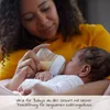 A woman is feeding a baby with a bottle. Produktbild-Vorschau