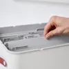 A hand is sorting through files in a document organizer. Produktbild-Vorschau